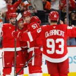 Mar 28, 2026; Detroit, Michigan, USA; Detroit Red Wings defenseman Moritz Seider (53) receives congratulations from teammates after scoring in the second period against the Philadelphia Flyers at Little Caesars Arena.