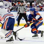 Nov 23, 2022; Elmont, New York, USA; New York Islanders center Mathew Barzal (13) controls the puck against Edmonton Oilers defenseman Evan Bouchard (2) during the second period at UBS Arena.