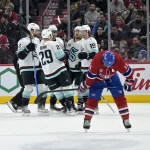 Dec 4, 2023; Montreal, Quebec, CAN; Seattle Kraken forward Jared McCann (19) celebrates with teammates after scoring a goal against the Montreal Canadiens during the second period at the Bell Centre.