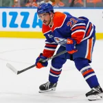 Sep 21, 2025; Edmonton, Alberta, CAN; Edmonton Oilers Forward Matt Savoie (22) looks for a loose puck against the Calgary Flames at Rogers Place