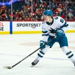 Feb 23, 2025; Calgary, Alberta, CAN; San Jose Sharks right wing Collin Graf (51) skates with the puck against the Calgary Flames during the third period at Scotiabank Saddledome.