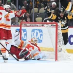 Jan 10, 2026; Pittsburgh, Pennsylvania, USA; Pittsburgh Penguins centers Thomas Novak (18) and Sidney Crosby (87) celebrate a score on Calgary Flames goalie Devin Cooley (1) however the goal was called off during the third period at PPG Paints Arena.