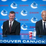 Jun 4, 2026; Vancouver, BC, CANADA; General manager Ryan Johnson and Manny Malhotra smile during press conference where the Vancouver Canucks introduce Malhotra as their new head coach during a press conference at Rogers Arena. :