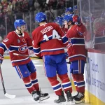 Oct 14, 2025; Montreal, Quebec, CAN; Montreal Canadiens forward Cole Caufield (13) celebrates with teammates including defenseman Lane Hutson (48) and forward Nick Suzuki (14) after scoring a goal against the Seattle Kraken during the second period at the Bell Centre.