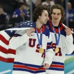 Feb 22, 2026; Milan, Italy; Quinn Hughes (43) of the United States and Jack Hughes (86) of the United States celebrate after defeating Canada in the men's ice hockey gold medal game during the Milano Cortina 2026 Olympic Winter Games at Milano Santagiulia Ice Hockey Arena.