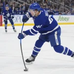 Mar 25, 2026; Toronto, Ontario, CAN; Toronto Maple Leafs defenseman Morgan Rielly (44) shoots the puck against the New York Rangers during the first period at Scotiabank Arena.