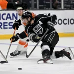 Jan 1, 2022; Los Angeles, California, USA; Philadelphia Flyers left wing Joel Farabee (86) and Los Angeles Kings defenseman Drew Doughty (8) battle for the puck in the second period of the game at Crypto.com Arena.