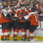 May 9, 2026; Philadelphia, Pennsylvania, USA; Philadelphia Flyers left wing Alex Bump (20) celebrates a goal teammates against the Carolina Hurricanes in game four of the second round of the 2026 Stanely Cup Playoffs at Xfinity Mobile Arena.