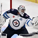 Apr 2, 2026; Dallas, Texas, USA; Winnipeg Jets goaltender Connor Hellebuyck (37) makes a glove save on a Dallas Stars shot during the second period at the American Airlines Center.