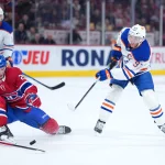 Dec 14, 2025; Montreal, Quebec, CAN; Montreal Canadiens forward Juraj Slafkovsky (20) blocks a pass from Edmonton Oilers forward Connor McDavid (97) during the third period at the Bell Centre.