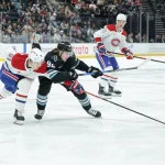 Nov 26, 2025; Salt Lake City, Utah, USA; Montreal Canadiens center Oliver Kapanen (91) and Utah Mammoth center Logan Cooley (92) fight for the puck during the first period at Delta Center.