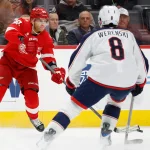 Apr 7, 2026; Detroit, Michigan, USA; Detroit Red Wings right wing Patrick Kane (88) passes defended by Columbus Blue Jackets defenseman Zach Werenski (8) in the second period at Little Caesars Arena.