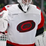Oct 25, 2025; Dallas, Texas, USA; A view of the logo on the jersey of Carolina Hurricanes goaltender Brandon Bussi (32) during the game between the Stars and the Hurricanes at the American Airlines Center.
