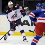 Mar 2, 2026; New York, New York, USA; Columbus Blue Jackets right wing Kirill Marchenko (86) takes a shot against New York Rangers left wing J.T. Miller (8) and defenseman Braden Schneider (4) during the first period at Madison Square Garden.