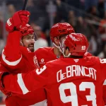 Mar 28, 2026; Detroit, Michigan, USA; Detroit Red Wings center Dylan Larkin (71) receives congratulations from teammates after scoring in the second period against the Philadelphia Flyers at Little Caesars Arena.