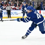 Mar 20, 2026; Toronto, Ontario, CAN; Toronto Maple Leafs defenseman Morgan Rielly (44) hits a slapshot against the Carolina Hurricanes in the first period at Scotiabank Arena.