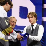 Jun 26, 2026; Buffalo, New York, USA; Gavin McKenna talks to NHL commissioner Gary Bettman after being selected with the first pick in the first round of the 2026 NHL Draft by the Toronto Maple Leafs at KeyBank Center.