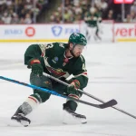 May 9, 2026; Saint Paul, Minnesota, USA; Minnesota Wild defenseman Quinn Hughes (43) spins away from the defense of Colorado Avalanche center Jack Drury (18) in the second period of game three of the second round of the 2026 Stanley Cup Playoffs at Grand Casino Arena.