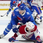 Nov 29, 2025; Denver, Colorado, USA; Colorado Avalanche center Nathan MacKinnon (29) hits Montreal Canadiens right wing Zack Bolduc (76) in the third period at Ball Arena.