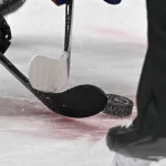 Feb 26, 2024; Dallas, Texas, USA; A view of the face-off circle and an NHL puck and the Dallas Stars logo and hockey sticks during a face-off in the third period of the game between the Dallas Stars and the New York Islanders at the American Airlines Center.