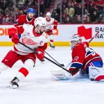 Jan 10, 2026; Montreal, Quebec, CAN; Montreal Canadiens goalie Jacob Fowler (32) makes a save against Detroit Red Wings center Dylan Larkin (71) during the second period at Bell Centre.