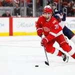Apr 7, 2026; Detroit, Michigan, USA; Detroit Red Wings center Dylan Larkin (71) skates with the puck in overtime against the Columbus Blue Jackets at Little Caesars Arena.