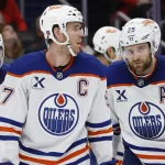 Apr 8, 2026; San Jose, California, USA; Edmonton Oilers center Connor McDavid (97) controls the puck while defended by San Jose Sharks right wing Collin Graf (51) during the first period at SAP Center at San Jose.