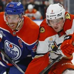 Mar 28, 2026; Edmonton, Alberta, CAN; Edmonton Oilers forward Connor McDavid (97) and Anaheim Ducks defensemen Ian Moore (3) battles for position during the first period at Rogers Place.
