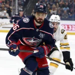 Apr 12, 2026; Columbus, Ohio, USA; Columbus Blue Jackets right wing Kirill Marchenko (86) and Boston Bruins defenseman Jonathan Aspirot (45) skate after a loose puck during the first period at Nationwide Arena.