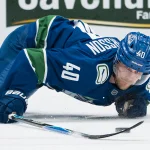 Mar 24, 2026; Vancouver, British Columbia, CAN; Vancouver Canucks forward Elias Pettersson (40) reaches for the loose puck against the Anaheim Ducks in the second period at Rogers Arena.