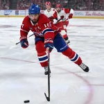 May 27, 2026; Montreal, Quebec, CAN; Montreal Canadiens center Nick Suzuki (14) skates with the puck against the Carolina Hurricanes during the third period in game four of the Eastern Conference Final of the 2026 Stanley Cup Playoffs at Bell Centre.