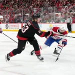 May 29, 2026; Raleigh, North Carolina, USA; Carolina Hurricanes right wing Jackson Blake (53) shoots the puck against Montreal Canadiens defenseman Alexandre Carrier (45) in game five of the Eastern Conference Final of the 2026 Stanley Cup Playoffs during the third period at Lenovo Center.
