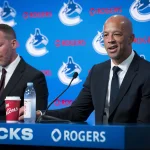 Jun 4, 2026; Vancouver, BC, CANADA; General manager Ryan Johnson listens to Manny Malhotra speak during press conference where the Vancouver Canucks introduce Malhotra as their new head coach during a press conference at Rogers Arena.
