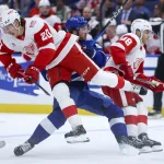 Apr 13, 2026; Tampa, Florida, USA; Tampa Bay Lightning defenseman Charle-Edouard D'Astous (51) collides with Detroit Red Wings defenseman Albert Johansson (20) in the third period at Benchmark International Arena