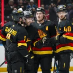 Oct 25, 2025; Vancouver, British Columbia, CAN; Vancouver Canucks forward Conor Garland (8) and forward Jake DeBrusk (74) and forward Brock Boeser (6) and forward Elias Pettersson (40) celebrate DeRusk\'s goal against the Montreal Canadiens in the second period at Rogers Arena. Mandatory Credit: Bob Frid-Imagn Images