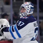 Nov 7, 2025; San Jose, California, USA; Winnipeg Jets goalie Connor Hellebuyck (37) waits for play to resume against the San Jose Sharks in the second period at SAP Center at San Jose. Mandatory Credit: David Gonzales-Imagn Images