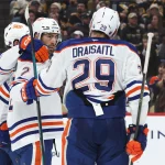 Dec 16, 2025; Pittsburgh, Pennsylvania, USA; Edmonton Oilers center Connor McDavid (97) and center Leon Draisaitl (29) congratulate defenseman Evan Bouchard (2) on his goal against the Pittsburgh Penguins during the second period at PPG Paints Arena. Mandatory Credit: Charles LeClaire-Imagn Images