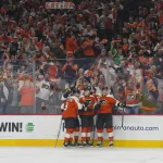 May 9, 2026; Philadelphia, Pennsylvania, USA; Philadelphia Flyers left wing Alex Bump (20) celebrates a goal teammates against the Carolina Hurricanes in game four of the second round of the 2026 Stanely Cup Playoffs at Xfinity Mobile Arena.