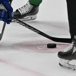 Dec 21, 2023; Dallas, Texas, USA; A view of the NHL puck and Stars logo and hockey stick and the face-off circle during the game between the Dallas Stars and the Vancouver Canucks at the American Airlines Center. Mandatory Credit: Jerome Miron-USA TODAY Sports