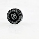 Nov 26, 2024; Montreal, Quebec, CAN; NHL puck with French logo during the warmup period before a game between the Utah Hockey Club and the Montreal Canadiens at the Bell Centre.
