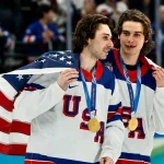 Feb 22, 2026; Milan, Italy; Quinn Hughes (43) of the United States and Jack Hughes (86) of the United States celebrate after defeating Canada in the men's ice hockey gold medal game during the Milano Cortina 2026 Olympic Winter Games at Milano Santagiulia Ice Hockey Arena.