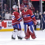 Jan 7, 2026; Montreal, Quebec, CAN; Montreal Canadiens players including goalies Jacob Fowler (32) and Jakub Dobes (75) celebrates the win against the Calgary Flames at the Bell Centre.