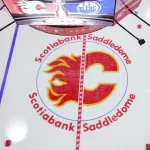 Beloved Flames broadcaster passes away after defining generations of Calgary hockey: Honouring Peter Maher May 18, 2022; Calgary, Alberta, CAN; General view of the Calgary Flames logo on the ice prior to the game between the Calgary Flames and the Edmonton Oilers in game one of the second round of the 2022 Stanley Cup Playoffs at Scotiabank Saddledome. Mandatory Credit: Sergei Belski-USA TODAY Sports
