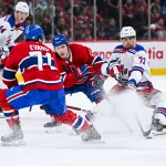 19 janvier 2025; Montréal, Québec, Canada; Owen Beck (62), centre des Canadiens de Montréal, défend la rondelle face à Filip Chytil (72), centre des Rangers de New York, durant la troisième période au Centre Bell.
