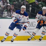 Mar 12, 2026; Dallas, Texas, USA; Edmonton Oilers center Connor McDavid (97) and center Trent Frederic (10) skates against the Dallas Stars during the game between the Stars and the Oilers at the American Airlines Center. Mandatory Credit: Jerome Miron-Imagn Images