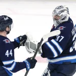 Apr 21, 2025; Winnipeg, Manitoba, CAN;Winnipeg Jets defenseman Josh Morrissey (44) and Winnipeg Jets goaltender Connor Hellebuyck (37) celebrate their victory against the St. Louis Blues in game two of the first round of the 2025 Stanley Cup Playoffs at Canada Life Centre. Mandatory Credit: James Carey Lauder-Imagn Images