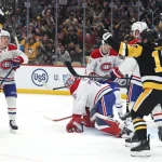 Dec 21, 2025; Pittsburgh, Pennsylvania, USA; Pittsburgh Penguins center Sidney Crosby (left) celebrates after scoring a goal to tie former center Mario Lemieux (not pictured) for the franchise all time points leader against the Montréal Canadiens during the first period at PPG Paints Arena.