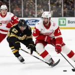 Nov 29, 2025; Boston, Massachusetts, USA; Detroit Red Wings center Dylan Larkin (71) goes around Boston Bruins center Sean Kuraly (52) during the third period at TD Garden.