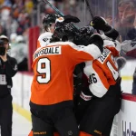 Mar 29, 2026; Philadelphia, Pennsylvania, USA; Philadelphia Flyers center Trevor Zegras (46) celebrates with teammates after scoring a goal against the Dallas Stars in overtime at Xfinity Mobile Arena