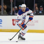 Apr 7, 2026; Salt Lake City, Utah, USA; Edmonton Oilers defenseman Evan Bouchard (2) skates with the puck against the Utah Mammoth during overtime at Delta Center.